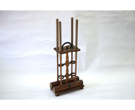 An F H Ayres croquet set with brass-bound mallets on stand (stand f/r), to/w four balls, six hoops and two pegs a/fWell used,