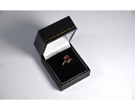 A 9ct yellow gold ring set rectangular step cut stone, possibly pink tourmaline, size NGood condition