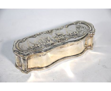 An antique Continental white metal snuff box of serpentine form, the hinged lid embossed with ships at sea, marks not identif