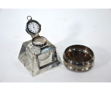 A heavy cut glass inkwell/paperweight of square tapering form with silver hinged cover fitted with a Swiss Fine Silver keywin