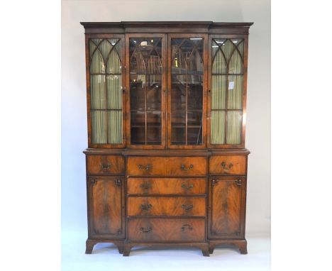 A Victorian style mahogany breakfront library bookcase, of diminutive proportions, the upper section with four astragal glaze
