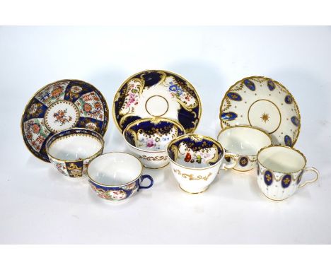 An 18th Century porcelain tea bowl and saucer, profusely painted and gilded with oriental flowers on a fielded blue ground (p
