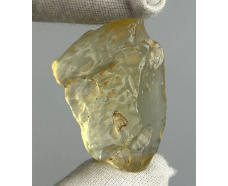 A NEOLITHIC SCRAPING TOOL IN DESERT GLASS TEKTITE, From the Tenerean Culture, tool was worked circa 5,000 years ago.Fashioned