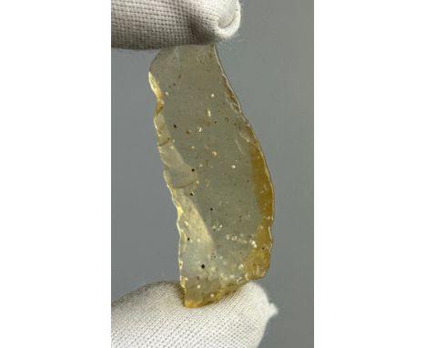 A NEOLITHIC SCRAPING TOOL IN DESERT GLASS TEKTITE, From the Tenerean Culture, tool was worked circa 5,000 years ago.Fashioned