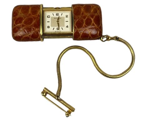 PROPERTY OF A TITLED LADY: A MOVADO SWITZERLAND PURSE WATCH ROLLED GOLD WITH BROWN CROCODILE SKIN LEATHER CASE, sliding mecha