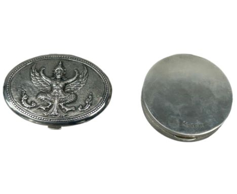 PROPERTY OF A TITLED LADY: TWO SILVER COMPACTS,One marked for Henry Wilkinson and Co with gilt interior and the other Burmese