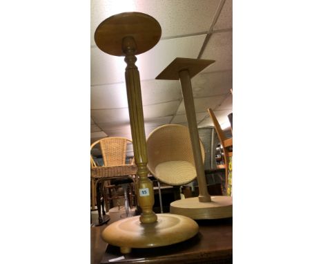 TWO LIGHT WOOD PEDESTAL STANDS AND A ROLLED RUG
