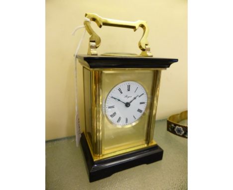 A gilt brass and polished slate carriage clock by Henley of England the single train movement signed 'Henley England',