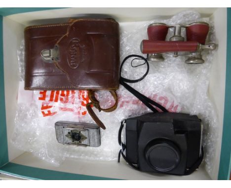 An Ensign Midget camera with silver-grey textured painted case, together with two other cameras and a pair of opera glasses. 