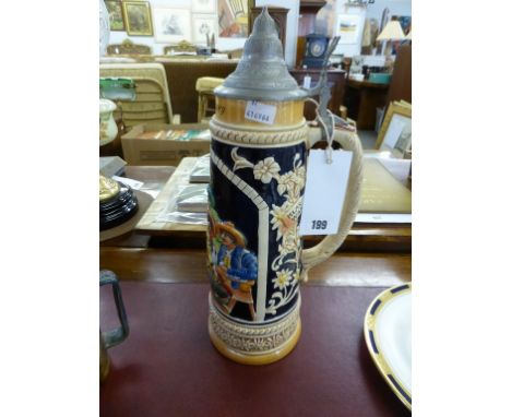 A vintage West German beer stein with pewter lid.