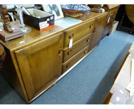 A vintage Ercol "Windsor" pattern sideboard. H156cm x D46cm x H69cm.