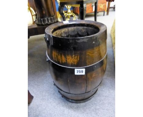 A barrel shaped stick/umbrella stand.