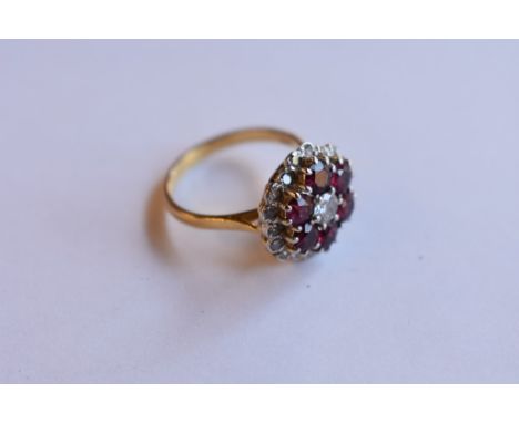 An 18ct yellow gold ruby and diamond cluster ring
