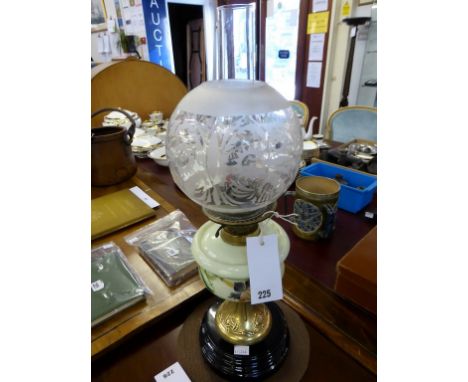 A Victorian oil lamp with etched glass shade.