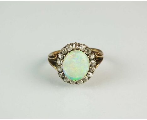 A 19th century opal and diamond cluster ring, designed as a central oval cabochon opal claw set within a border of old mine c