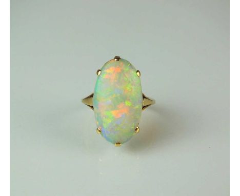 A single stone opal ring, the oval opal cabochon claw set in yellow metal to yellow metal shank, stamped '18ct', ring size N,