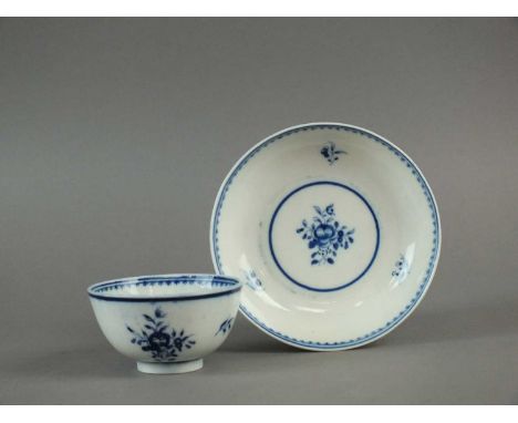 A Caughley tea bowl and saucer circa 1780-93 painted in blue with the uncommon 'Simple Posy' pattern featuring foliage and fl