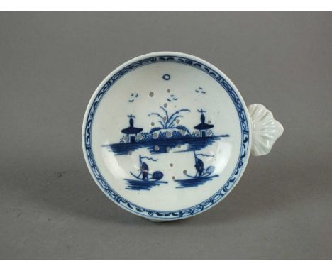 A Caughley egg drainer circa 1780-90 the pierced bowl of circular form with shell-form handle, painted in blue with the 'Isla