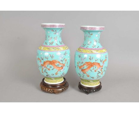 A pair of Chinese export vases, each painted with red and black five-claw scaly dragons, seal marks to underside, 29 cm high,