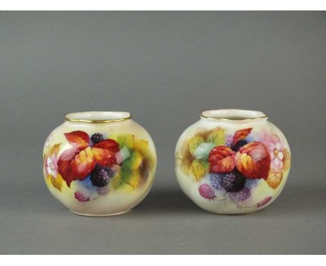 A pair of Royal Worcester vases circa 1932 and 1952 of small ovoid form, painted with blackberries and autumnal flowers by Ki