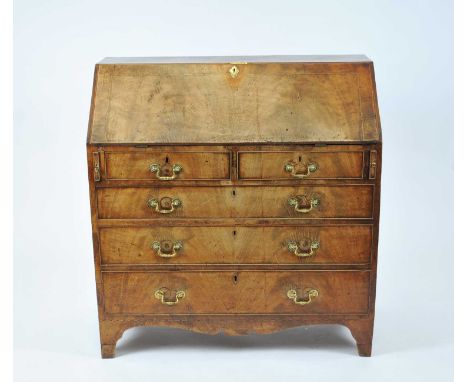 An early George III walnut and mahogany bureau, the figured fall with chequered stringing and a chain banding, above two shor