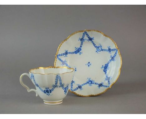 A Caughley 'Rose Festoons' teacup and saucer circa 1786-94 the cup of fluted double-ogee form with moulded ear-shape handle, 