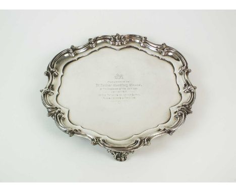 An Elkington &amp; Co silver presentation salver, Birmingham 1916, of lobed circular form with scroll border, the centre engr