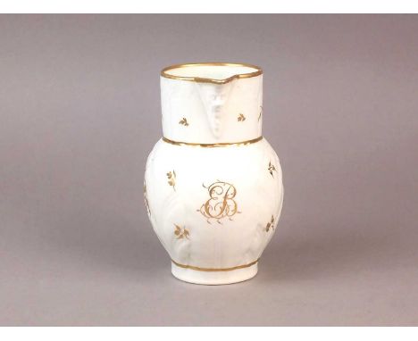 A Caughley gilt and white maskhead jug circa 1790 of cabbage leaf moulded form, decorated with the monogrammed initials 'EB' 