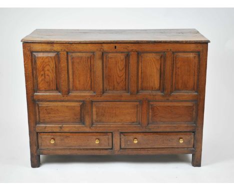 An 18th century oak mule chest, the 4-section top above five portrait fielded panels, over three landscape fielded panels, wi
