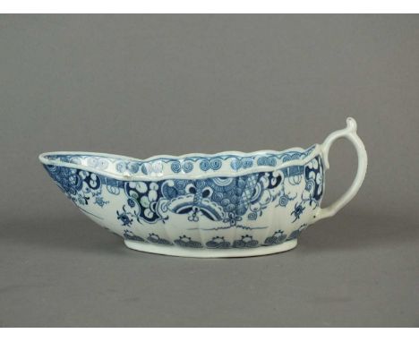 A Worcester 'Doughnut Tree' sauceboat circa 1775-80 of gently fluted form, decorated with a lattice, fish roe and butterfly b