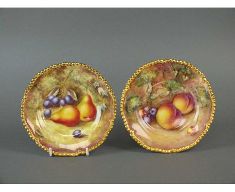A pair of Royal Worcester side plates mid-20th century painted with fruit by K. Bettison and English, with gilt-edged gadroon