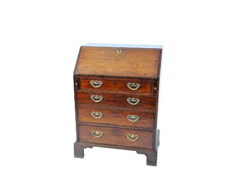 A late 18th / early 19th century mahogany bureau of diminutive proportions, with a partitioned interior fitted with drawers a