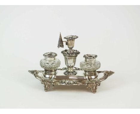 A Victorian silver ink stand, Henry Wilkinson &amp; Co, Sheffield 1866, the marquise shaped stand with cast scroll border and