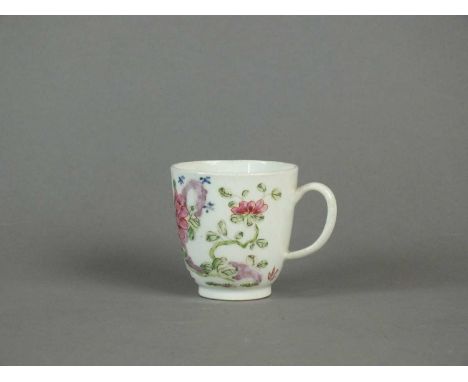 A Bow coffee cup circa 1755-60, painted in famille rose enamels with flowering peony and chrysanthemum before holey rockwork,