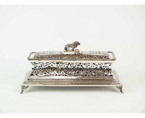 A 19th century Indian white metal scroll casket, of elongated rectangular form with pierced foliate decoration, removable cas
