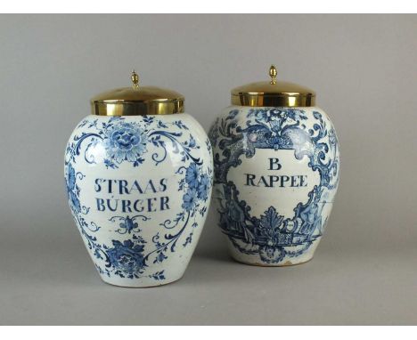 Two large 18th century delft dry drug jars with copper covers, decorated in blue with inscriptions ‘Straas Burger’ and ‘B Rap
