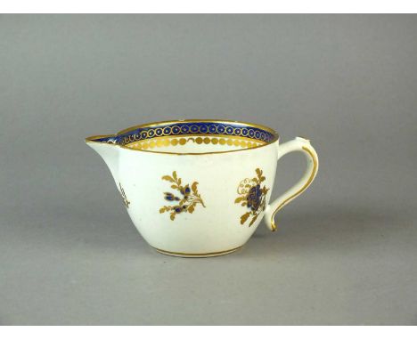 A Caughley milk jug circa 1790-92 of plain, bute form with Chinese-style handle, decorated in underglaze blue and gilt, paint