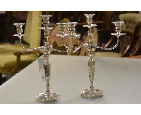 A pair of George V silver three-light candelabra, George Edwards &amp; Sons, Sheffield 1910, each stick with detachable drip 