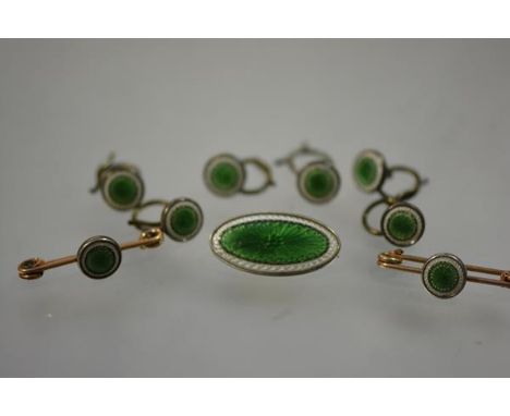 A lady's silver-backed enamel dress set, c. 1900, in engine-turned green and white enamel, comprising an oval brooch, pair of