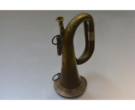 An Imperial German First World War white-metal mounted brass military bugle, with Prussian eagle, manufacturer Deutsche Signa