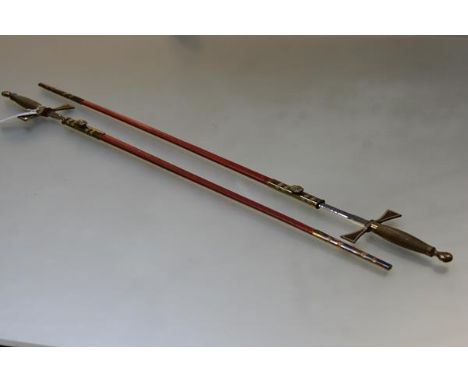 A pair of Masonic ceremonial swords, each with brass wire-bound hilt and red leather scabbard, the blades by Wilkinson Sword 