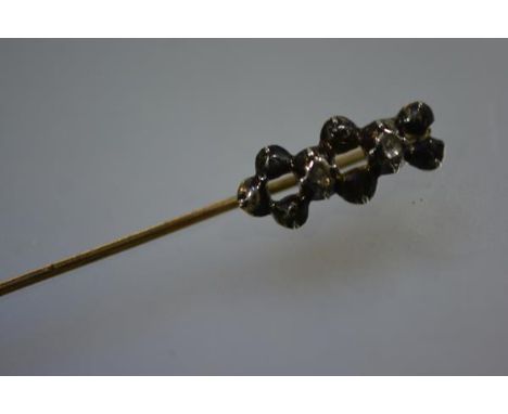 A late 19th century stick pin, set with two old-cut diamonds, cased.