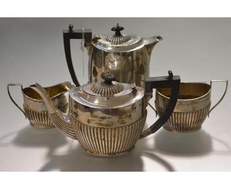 A George V three piece silver tea service, William Devenport, Birmingham 1922, each piece half reeded; together with a coffee