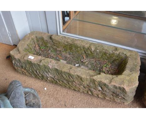 A long rectangular weathered stone garden trough planter. 20cm by 90cm by 35cm