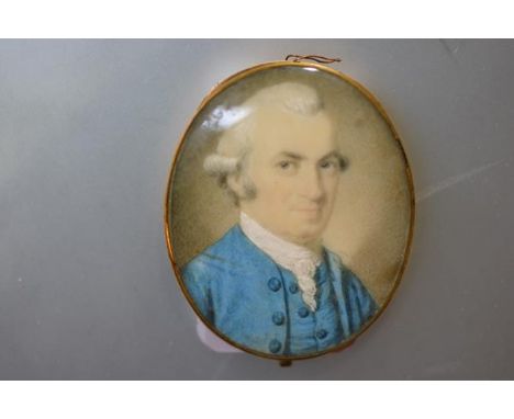 English School, c. 1780, a portrait miniature of a gentleman in a blue coat, watercolour on ivory, in a yellow metal case fit