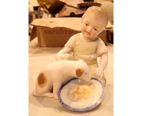 Ceramic figurine of a child feeding his dog 