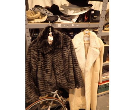 Ladies short faux fur jacket a full length jacket with faux fur collar and a shelf of ladies handbags