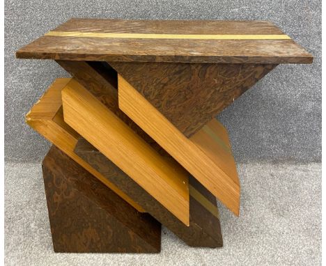 A mid-century Italian veneered console or centre table with a burr walnut top above a stylised base with diagonal shards of i