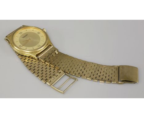 A gentleman's gold plated Tissot quartz watch, on a 9ct gold bracelet