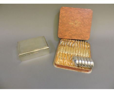 A silver engine turned cigarette box, together with a cased set of spoons